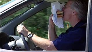 A man eating while driving