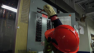 A man using electrical safety procedures