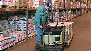 A man safely using a powered pallet jack