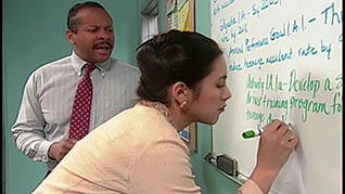 A women writing on a whiteboard