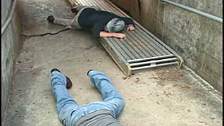 Two workers that have fallen to the ground due to a lack of proper H2S training