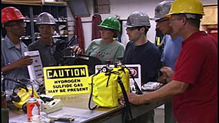 Workers in hard hats receiving H2S training