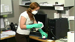 A women disinfecting her computer