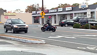 A motorcycle driving on the wrong side of the road