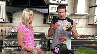 A man and women making a smoothie