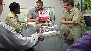Workers going over the SDS manual