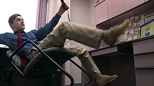 A man falling out of his chair
