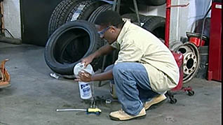 An auto facility worker in the mechanic safety training video