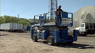 A man operating a sissor lift