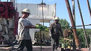 Two workers practicing oilfield hand safety with ropes