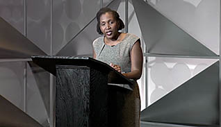 A women speaking at a conference