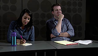 Two people taking notes
