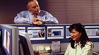 Two employees talk positively in an office