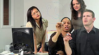 People drawing on a whiteboard