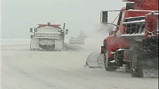 working with several snow removal vehicles