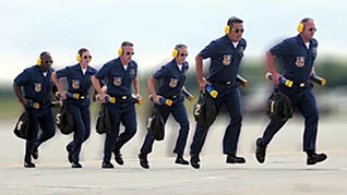 A group of policemen demontrate teamwork skills as they run in a line