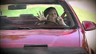 A women talking on the phone whille driving