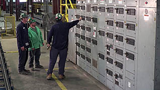 Man talking to two employees