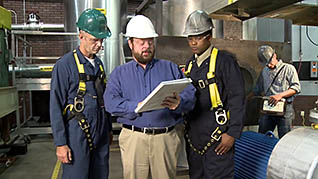 Three men talking over plans