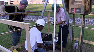 Three men working on a site