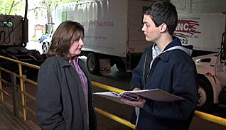 A young man talking to an elderly woman