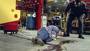 A man helping his co-worker after an accident