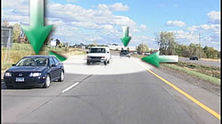 A step van is on the road with one sedan in front of it and one behind