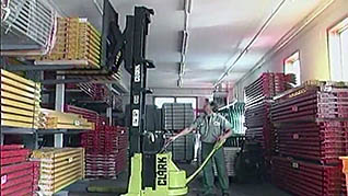 A man using a powered pallet jack