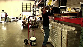 A man properly lifting a barrel