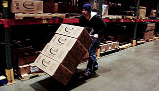 A man moving boxes in an office