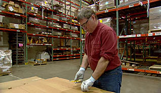 A man safely using a utility knife