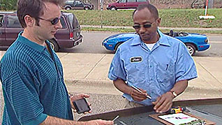 A man explaining the details of a car accident to a police officer