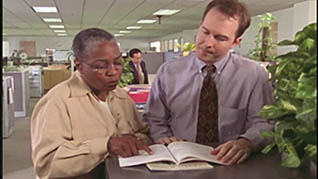 A man and women reading a manuel