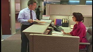A man talking to the receptionist