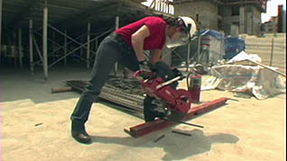 A worker using a piece of heavy equipment in the Stretching for Construction Workers training video