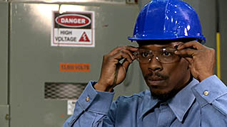 A worker wearing protective eyewear for increased electrical safety