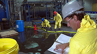 Guys cleaning up a hazardous spill