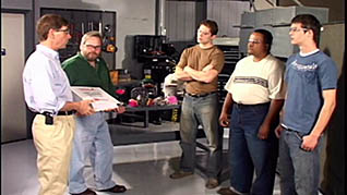 A man in a button up shirt and khaki pants training his employees how to use hexavalent chromium