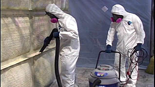Two workers in hazmat suits use hexavalent chromium after their employee training