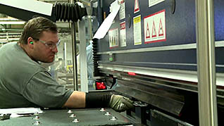 A mans hand stuck in a machine