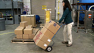 A women properly moving boxes