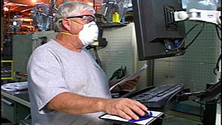 A man wearing a mask while working