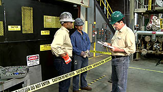 Two men talking to an employee behind caution tape