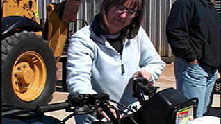 A women turning an ATV on