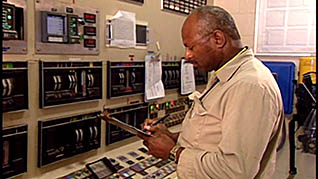 A man keeping track of how much oil is being transferred