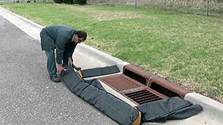 A man setting up to clean a storm drain