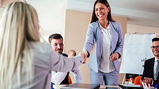 Woman shaking an employees hand