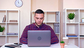 Man typing on a laptop