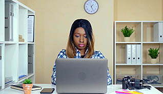 Woman typing on a laptop