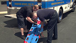 First responders cleaning a stretcher